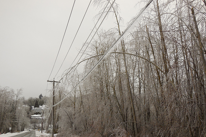 Ice covered power lines during winter snow storm
