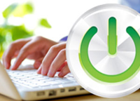 Power-on sign in front of a person typing on a laptop Power-on sign in front of a person typing on a laptop