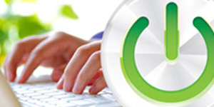 Power-on sign in front of a person typing on a laptop