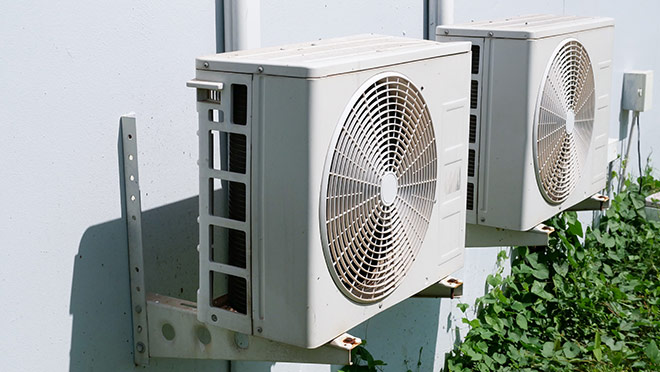 Image of heat pumps on the side of a building