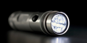 Silver flashlight with a dark background