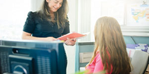 Two employees talking at a desk