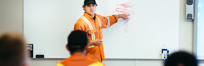 Power line technician in classroom training apprentices