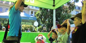 Community outreach representative educating a group of children at an event