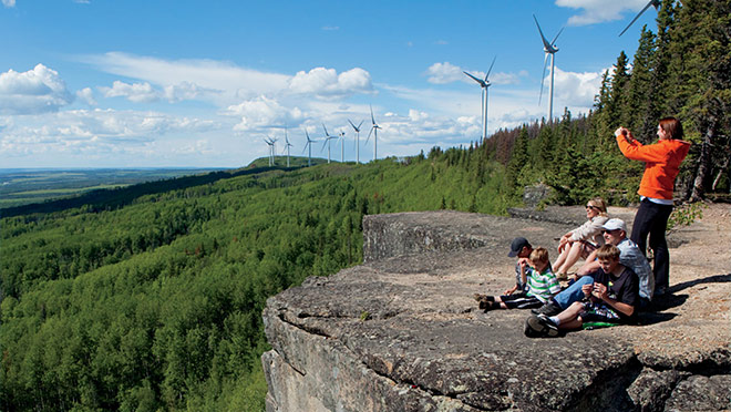 Image of a family in front of Bear Mountain's wind turbines