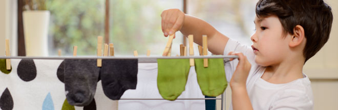 Young boy hanging laundry Young boy hanging laundry