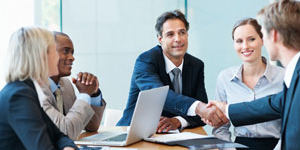 Shaking hands at a meeting in a conference room
