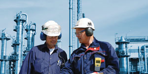 Two men discussing work at an industrial plant