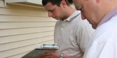 Two men inspecting a residential home