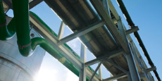 Industrial plant pipes with sky and lens flare