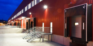 Modern red warehouse exterior with lights on