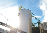 Industrial plant tank with sky and lens flare Industrial plant tank with sky and lens flare