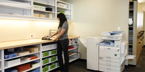 Woman in supply room with photocopier