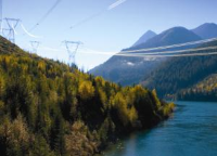 Transmission towers running down the mountain across the water