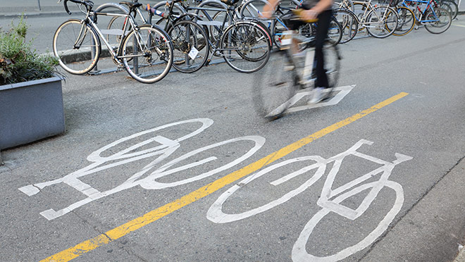 Image of a cyclist riding on a downtown Vancouver bike lane