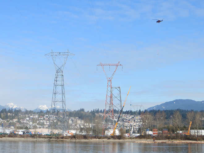 BC Hydro crews using a helicopter to string transmission lines during the final phase of the Fraser River restoration project.