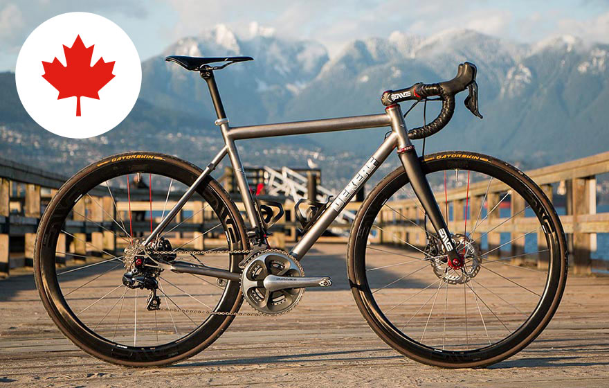 Dekerf bicycle pictured on a dock with mountains in the background
