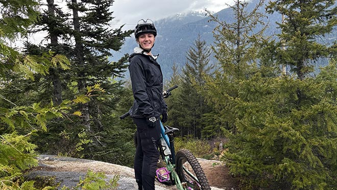 Charlotte Reid, Community Energy Coordinator for Squamish and Whistler, poses with her mountain bike