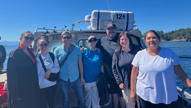 Seven members of the Tla'Amin Nation Housing Department on a boat