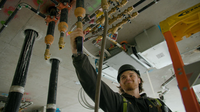 Steamfitter or pipefitter maintaining a piping system