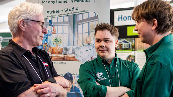 Representatives from various companies chat at the HPCN trade show