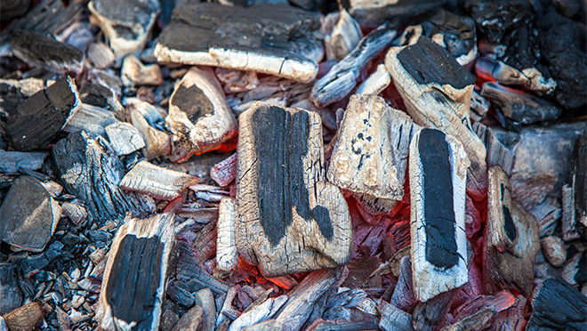Campfire embers still burning Embers of a dying campfire are still burning and could be dangerous.