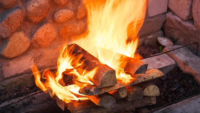 Fireplace logs arranged log-cabin style Log-cabin style stacking of wood in a fireplace or as a campfire is a highly-effective way of getting a fire going.