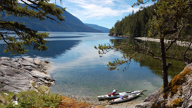 A pair of kayaks on a lake by the Sunshine Coast