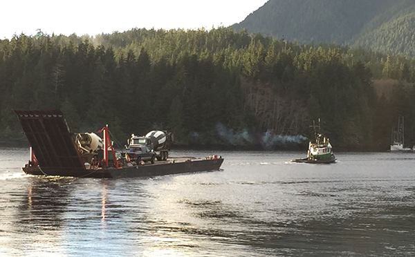 Tug boat pulling a BC Hydro barge to help bring equipment to a remote community in B.C. Tug boat pulling a BC Hydro barge to help bring equipment to a remote community in B.C.