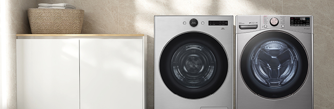 Washing machine and dryer next to cabinet with laundry basket