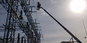 technician in bucket truck inspecting distribution facility