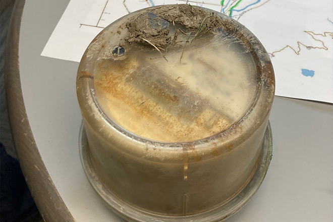 Flood damaged electric meter covered in mud
