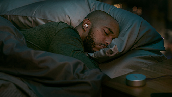 Image of a man sleeping while wearing Bose noise-masking earbuds Image of a man sleeping while wearing Bose noise-masking earbuds