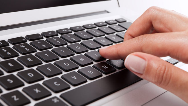 Hands on macbook laptop keyboard full width Hands on macbook laptop keyboard full width