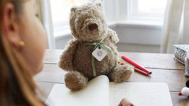 Image of a Tile bluetooth tracker tied to a teddy bear Image of a Tile bluetooth tracker tied to a teddy bear