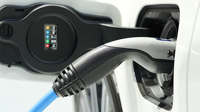 Image of a charger plugged into an electric vehicle Image of a charger plugged into an electric vehicle