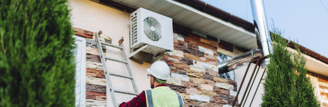Technician in uniform repairing heat pump Technician in uniform repairing heat pump