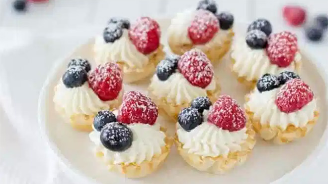 No-bake cheesecake bites and blueberries on countertop