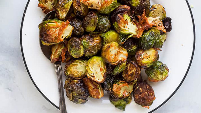 A bowl of parmesan garlic brussel sprouts made in an air fryer