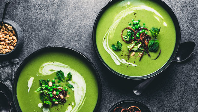 Two bowls of tasty green pea soup from above