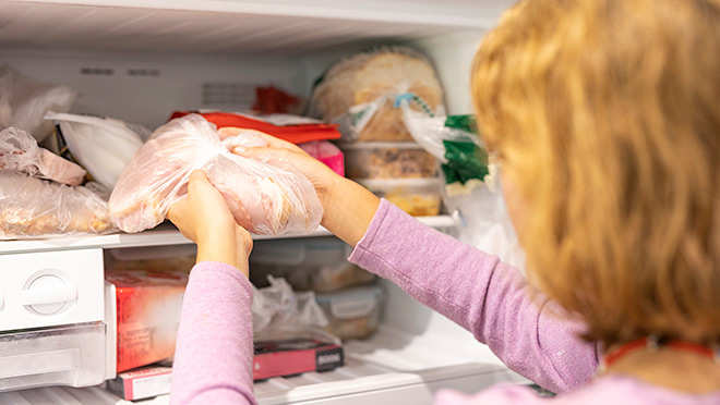 Turkey being removed from a refrigerator freezer