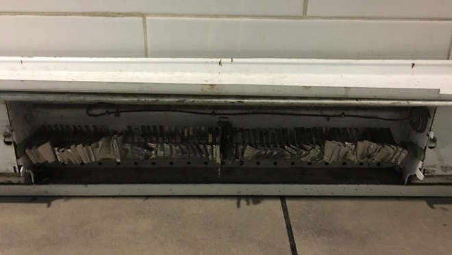 Photo of a damaged baseboard heater