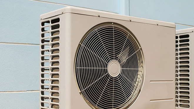 Image of a heat pump on the exterior of a building