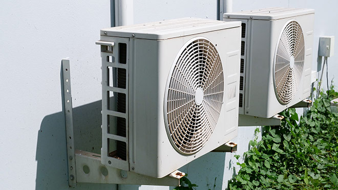Image of heat pumps on the side of a building Image of heat pumps on the side of a building