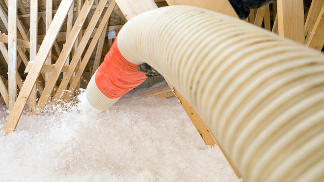 Image of insulation being sprayed in a house attic Image of insulation being sprayed in a house attic