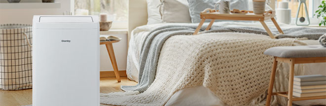 A portable air conditioner in a bedroom.