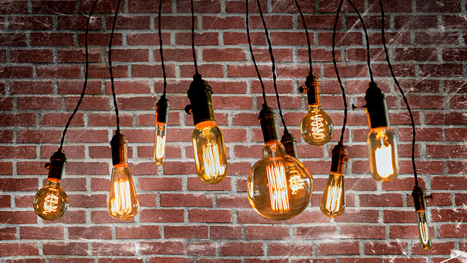 Image of LED filament bulbs against a brick wall Image of LED filament bulbs against a brick wall