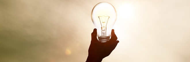 Light bulb in one hand from sunlight