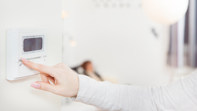 Image of thermostat being adjusted Space heaters consume a huge amount of electricity.