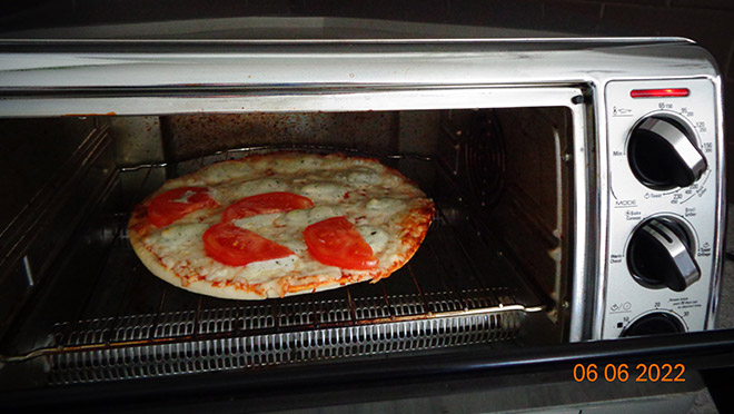 Pizza cooking in Bonnie Barr's toaster oven